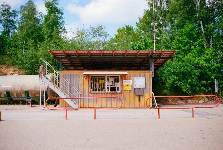 a building sits empty as it is surrounded by trees