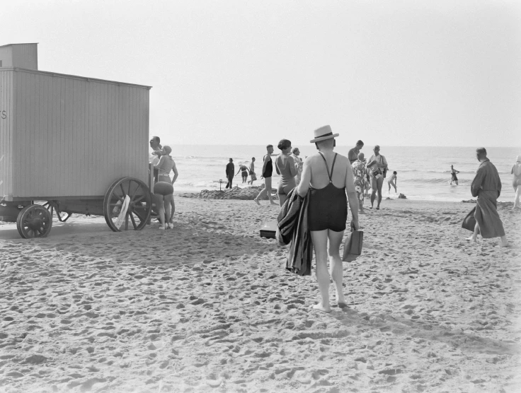 a man and woman are walking along the beach