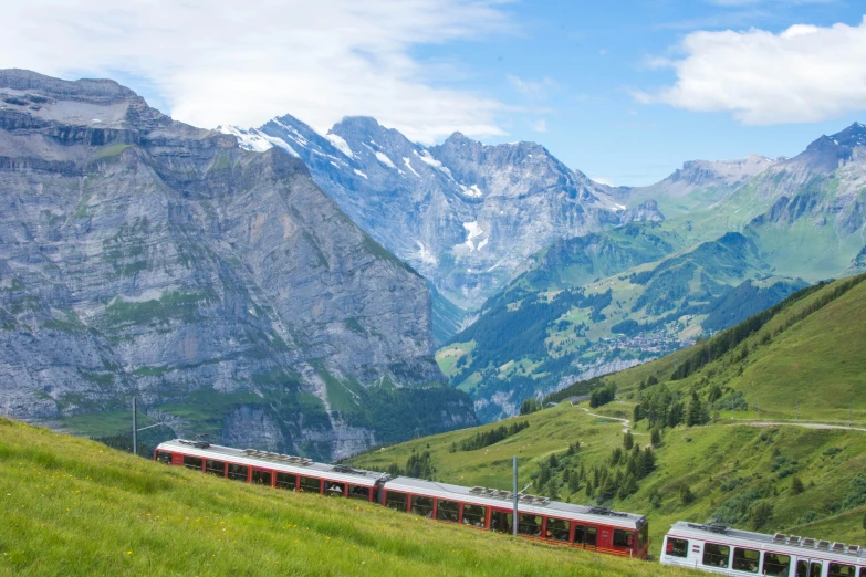 a train is on a train track that runs through the valley