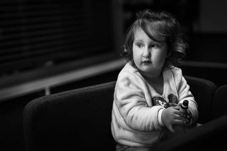 a toddler holding a remote in her hand
