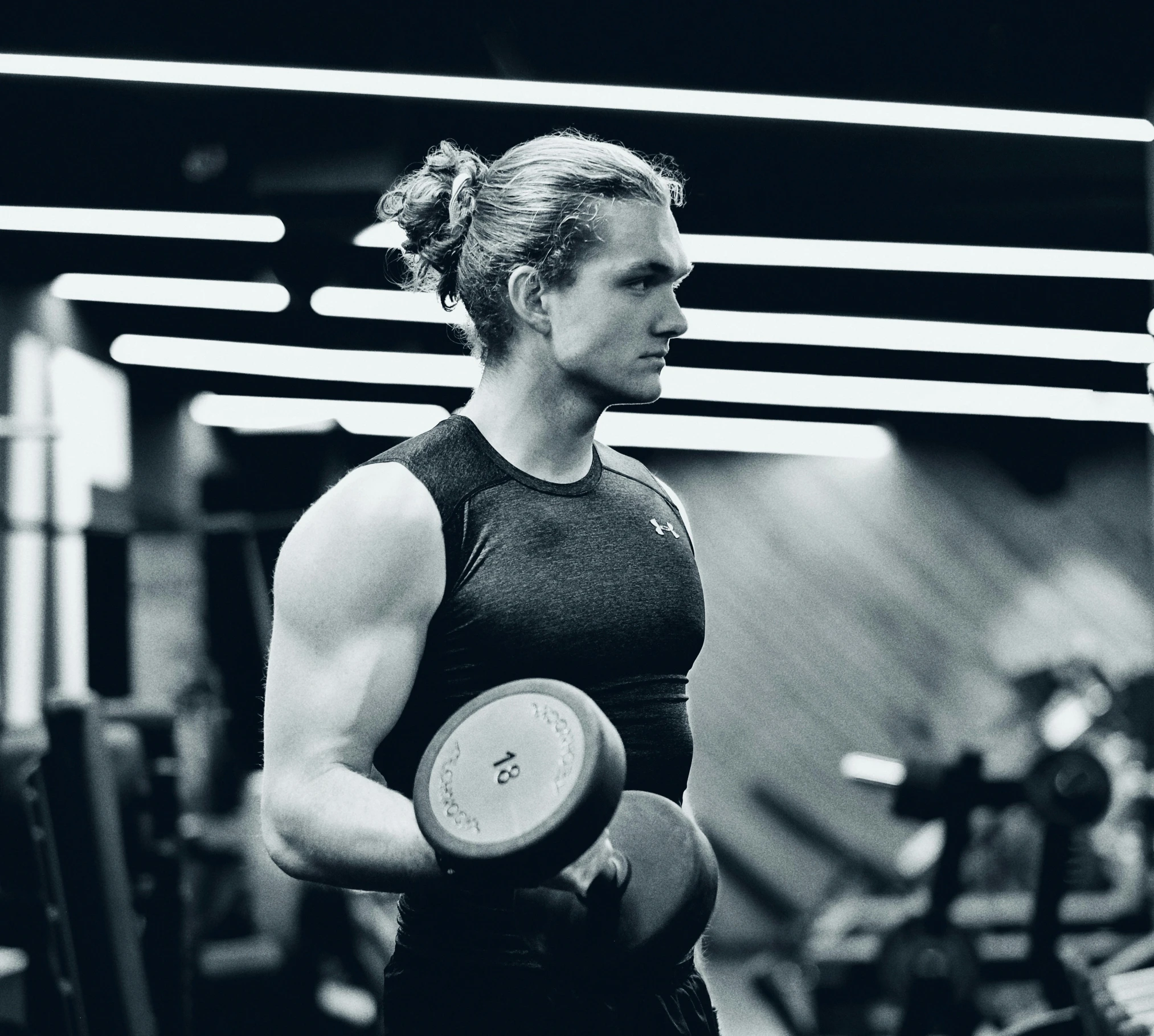 a woman with dumbbells in the gym on a bench