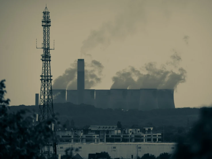 smoke stacks out the top of a factory building