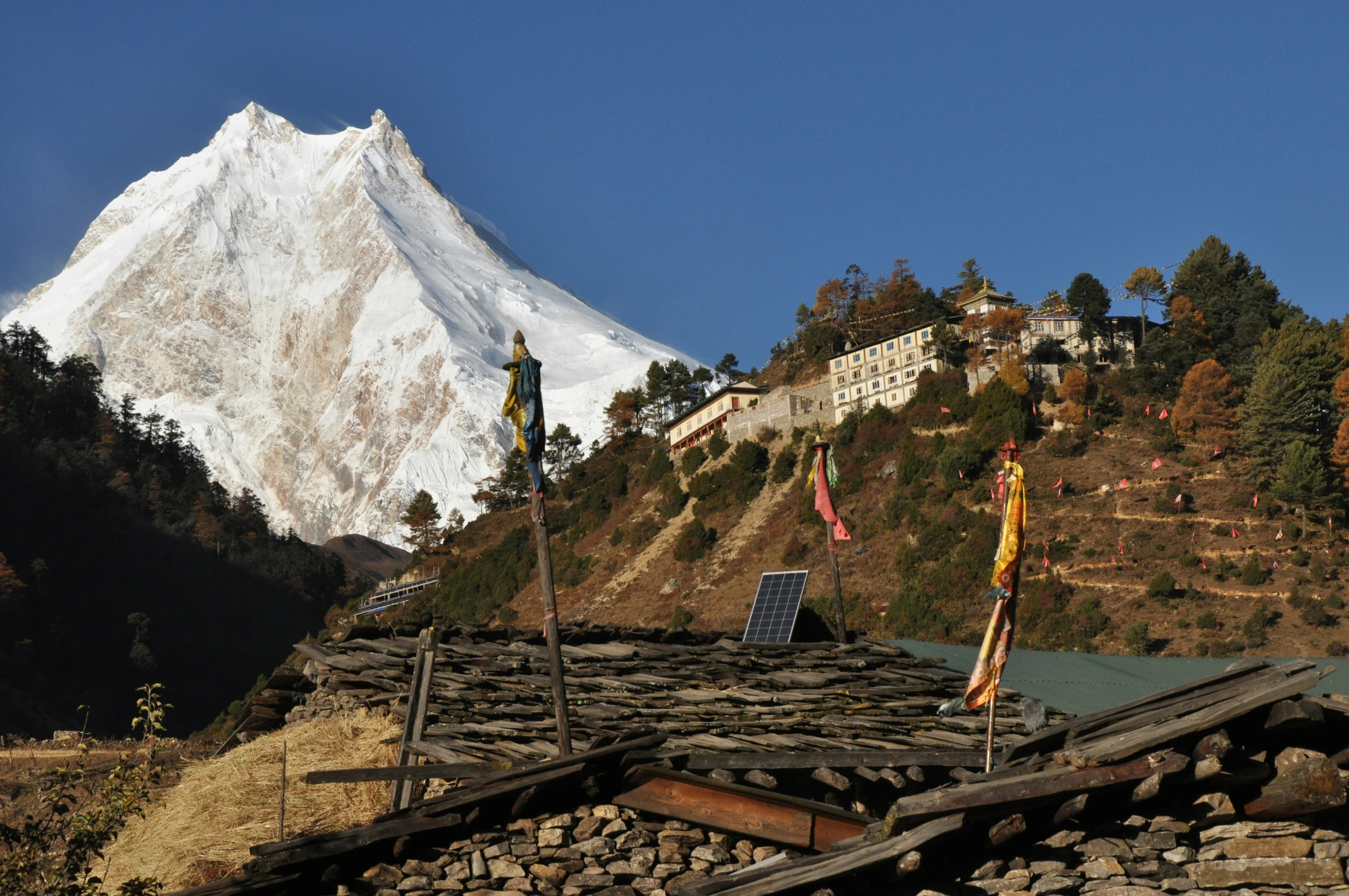 there is a snow - capped mountain on the top of a hill