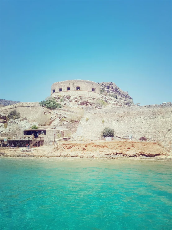 a very old, deserted building by the water