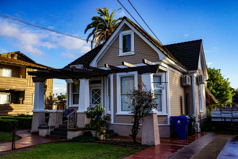 there is a house on the corner with trees