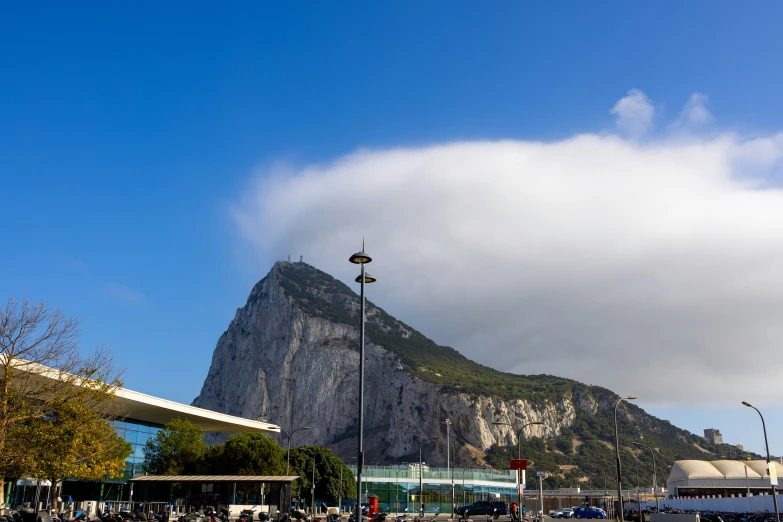 a bridge is crossing over water by a mountain