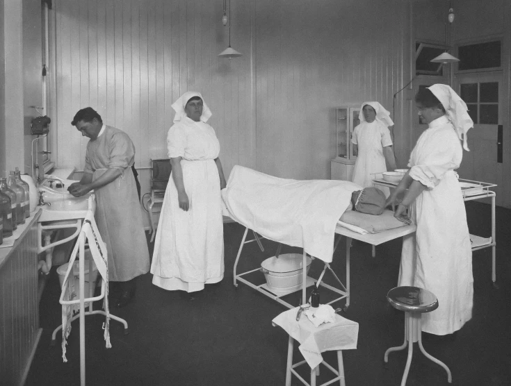 this is two nurses standing by the operating table