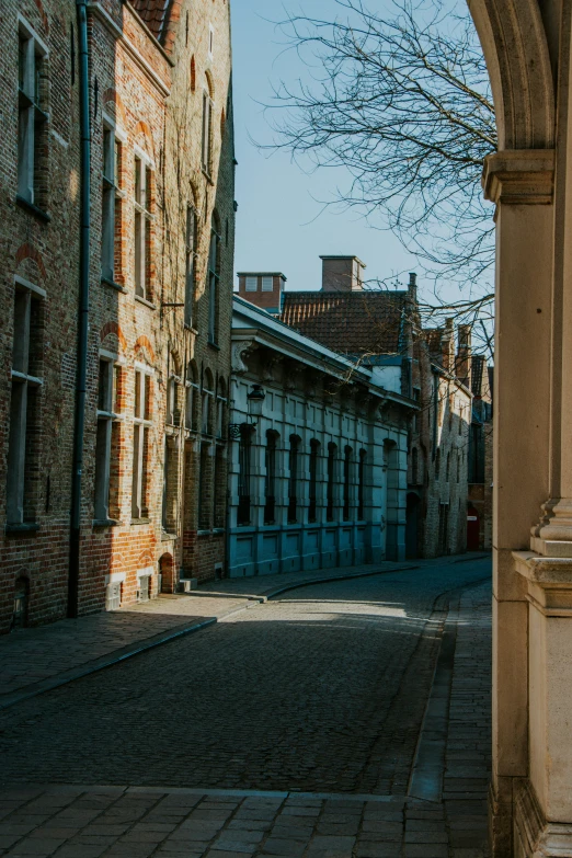 a street with old brick buildings and a doorway