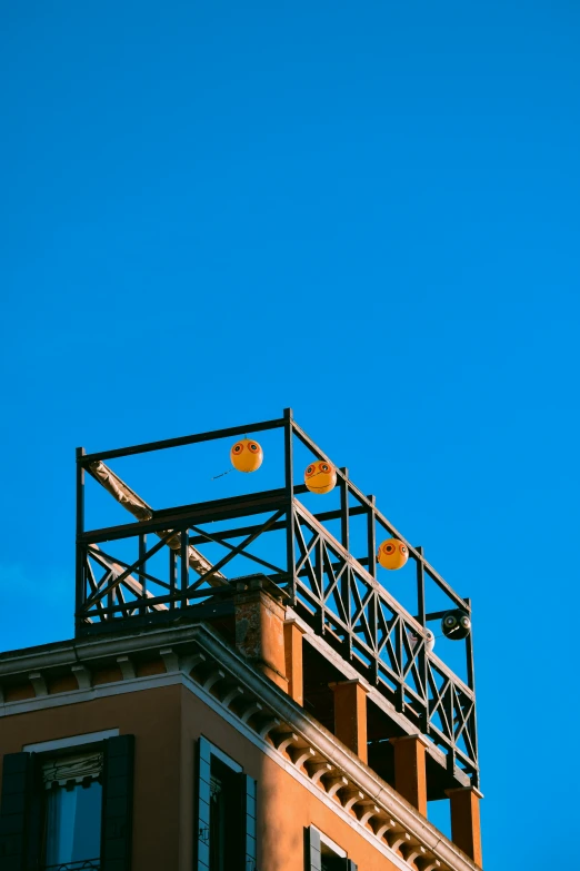 a building with two yellow light posts on the top of it