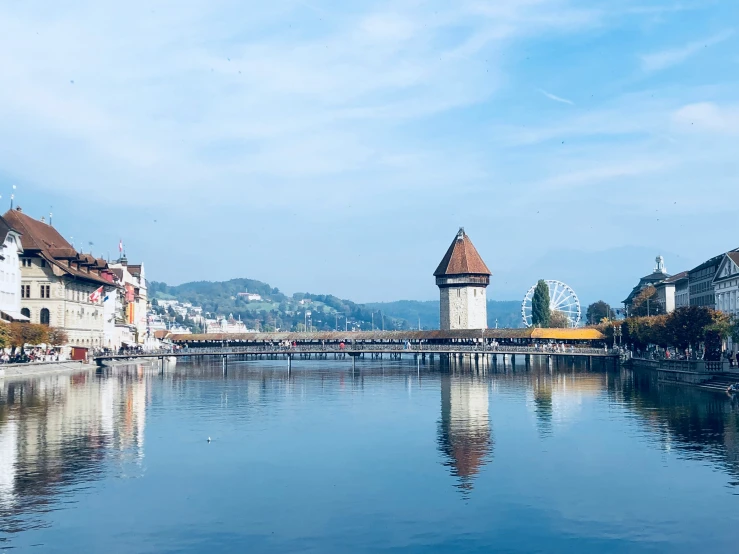 the city of luce is sitting on a river and there are houses with towers