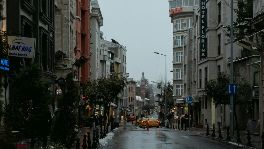 a rainy city street and street light on a cloudy day