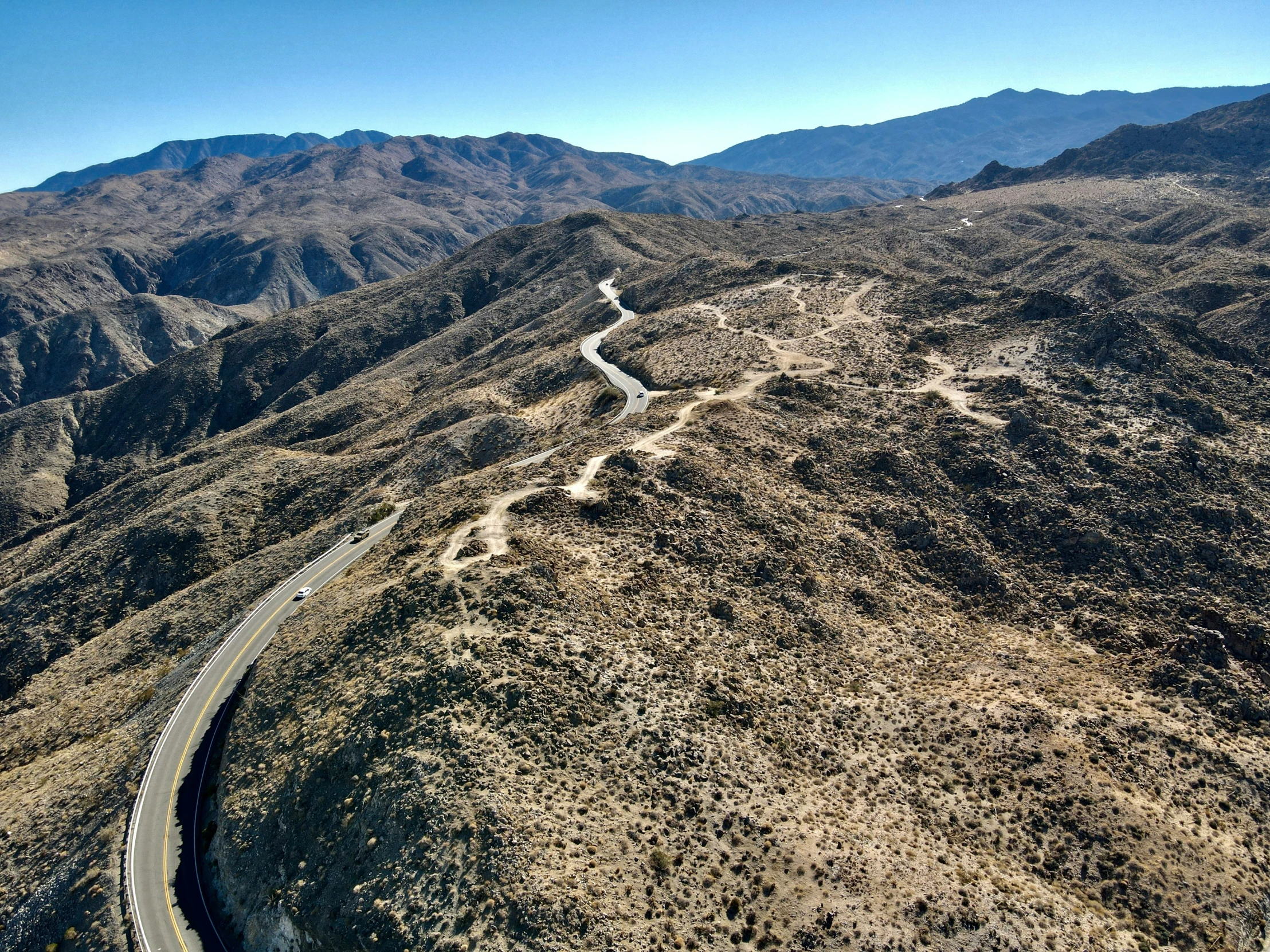 aerial view of mountains and the curved road