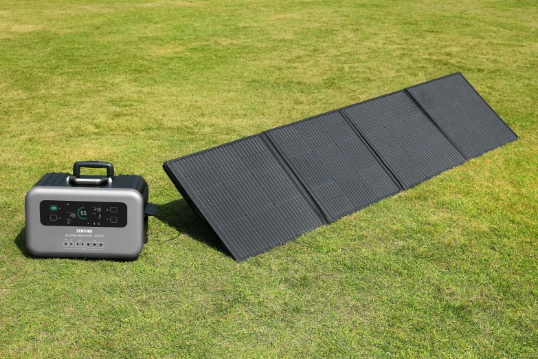 a black and white picture and a gray and black device on some grass