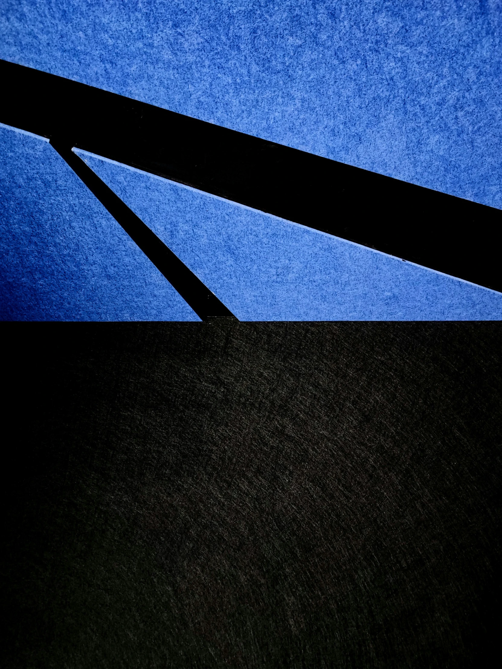 black square structures against a blue sky