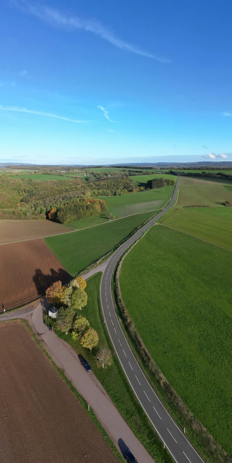 two roads going through an open field and a truck