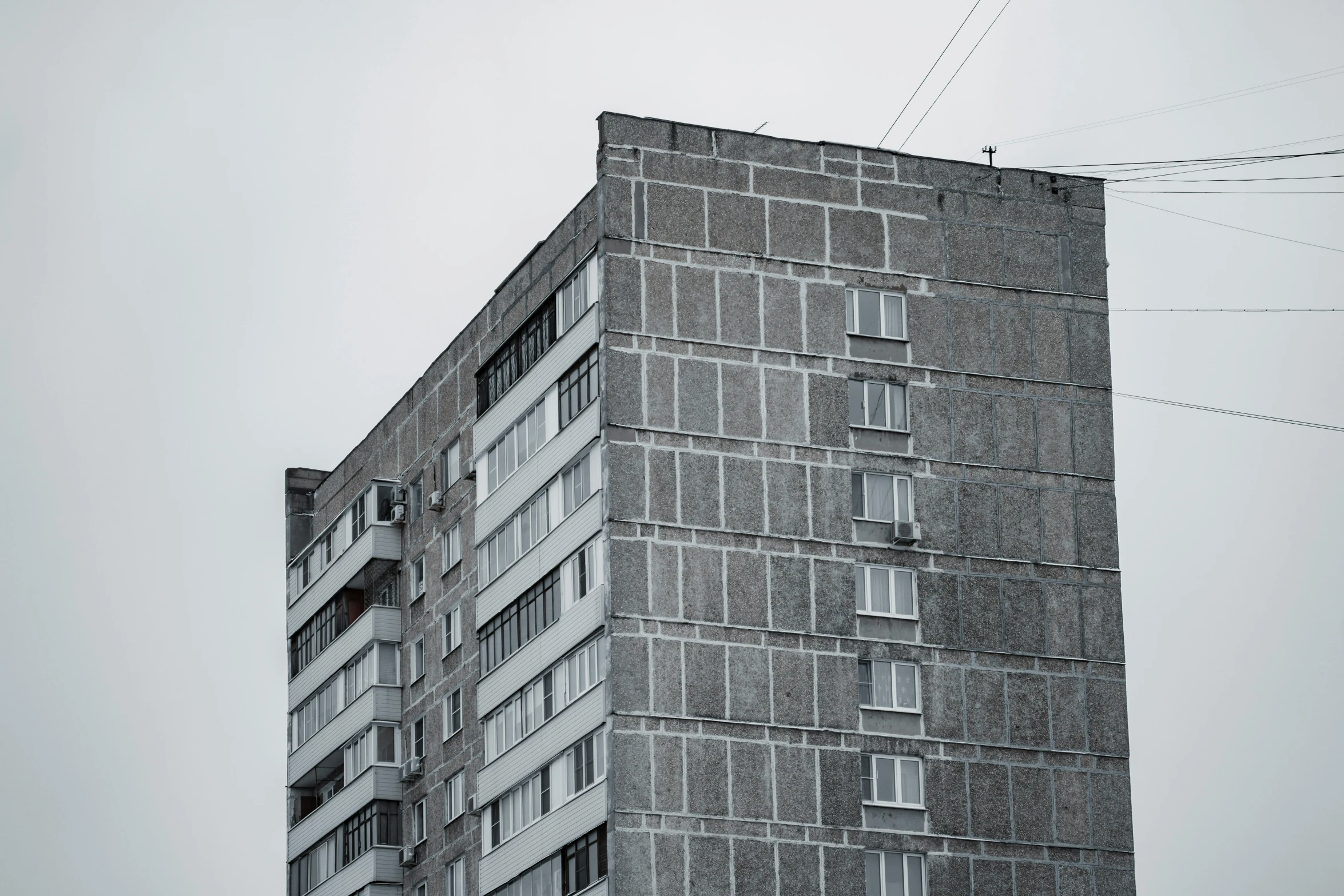 an older building near the street, with power lines in the background