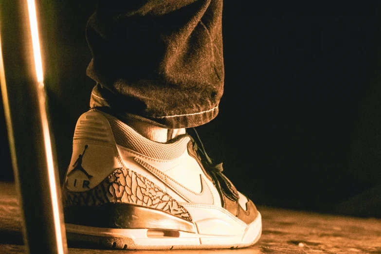 a man is standing on a skateboard next to his feet