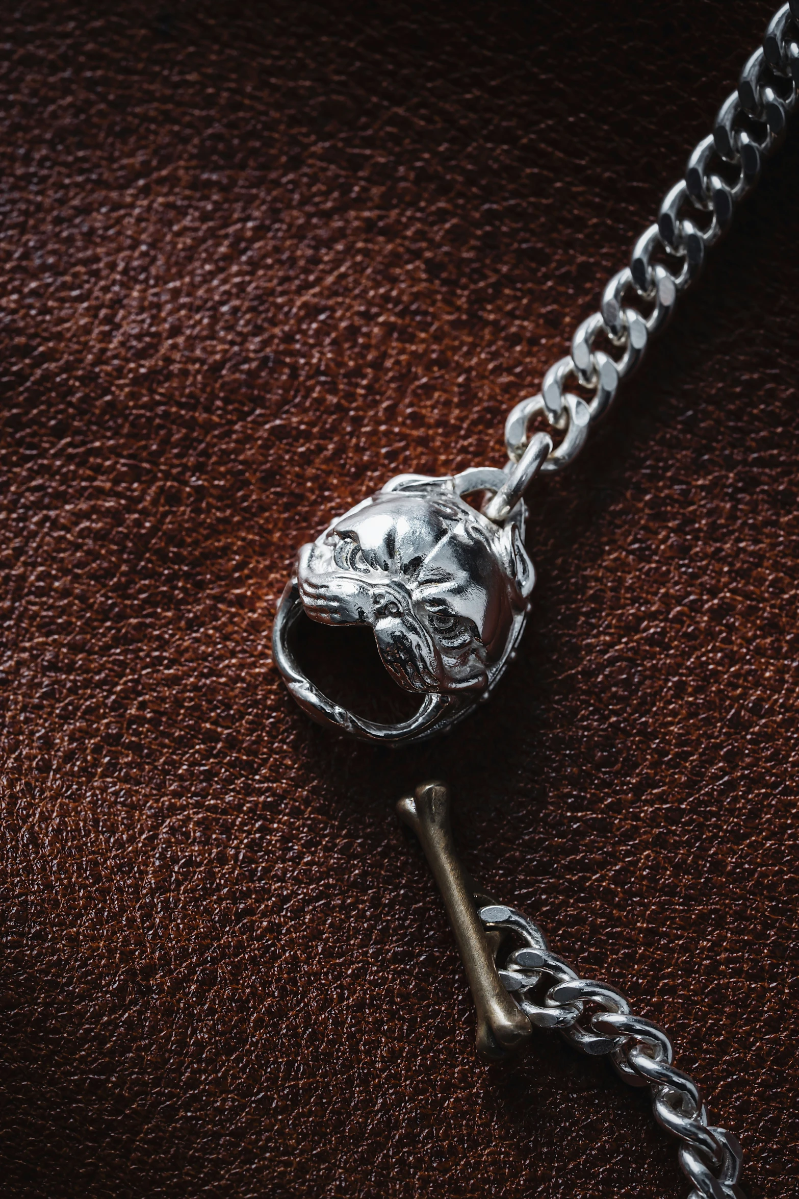 a chain has a skull and a key on it