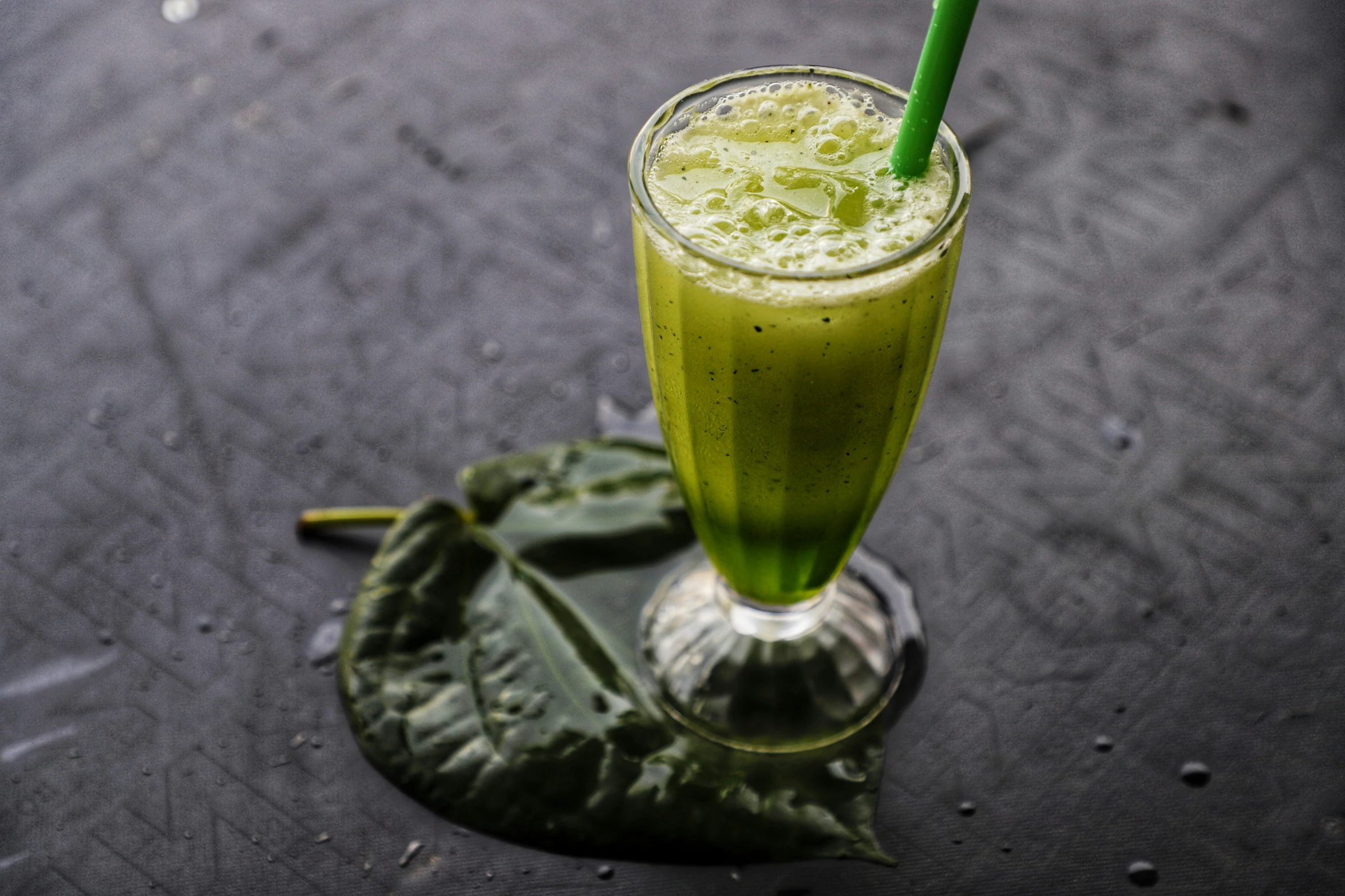 a drink that has been placed on a leaf