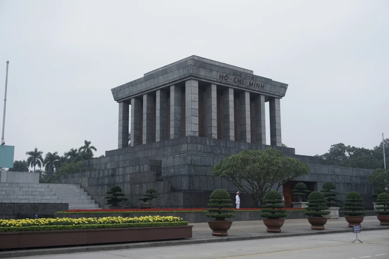 a large statue is in the middle of several flower boxes