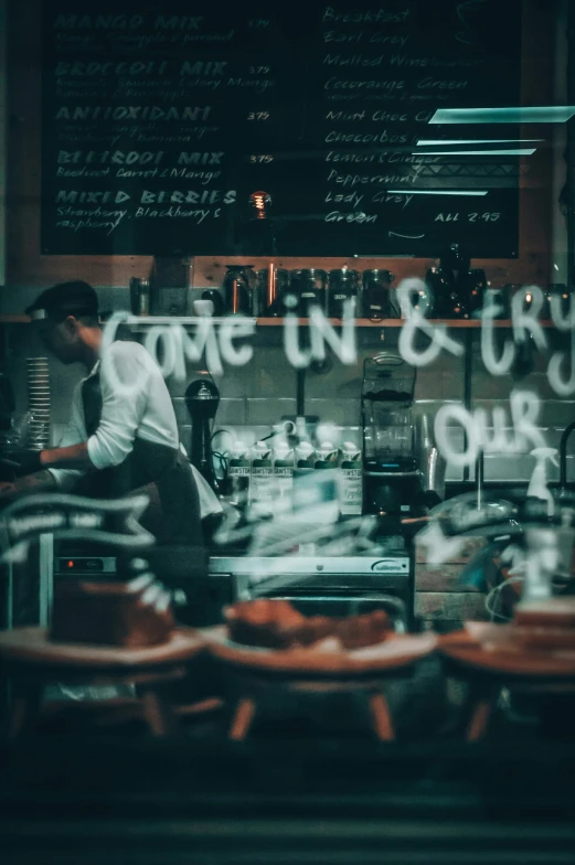 a man in the window of a bakery with some writing on it