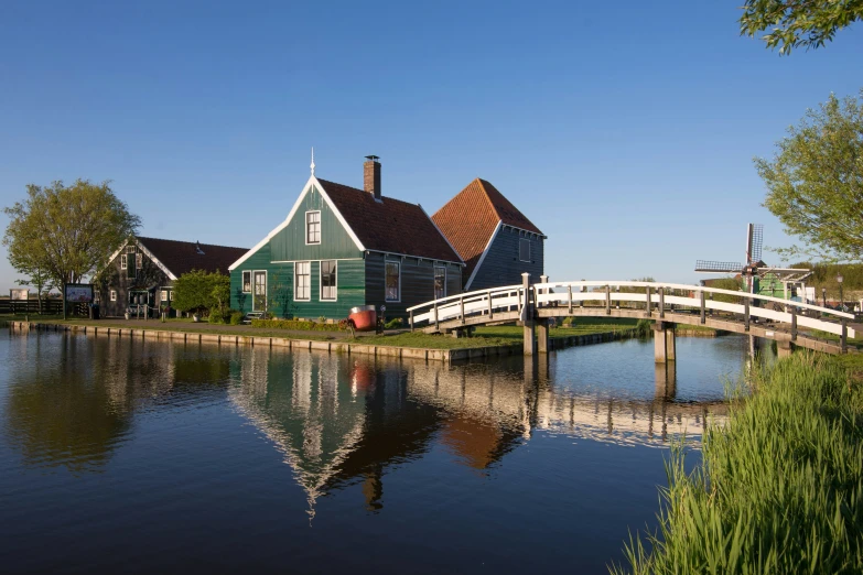 a house is sitting next to a body of water