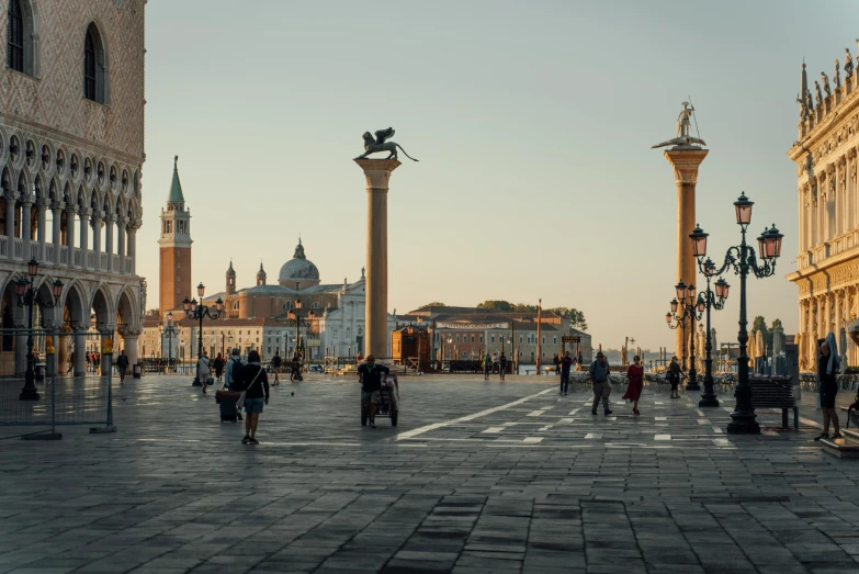 people walk along the stone streets in a european city