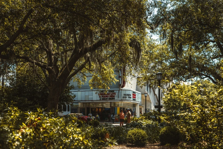 a white house with trees and bushes around it