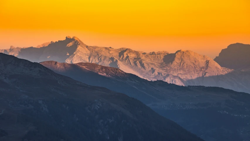 mountains with snow and light in the sky