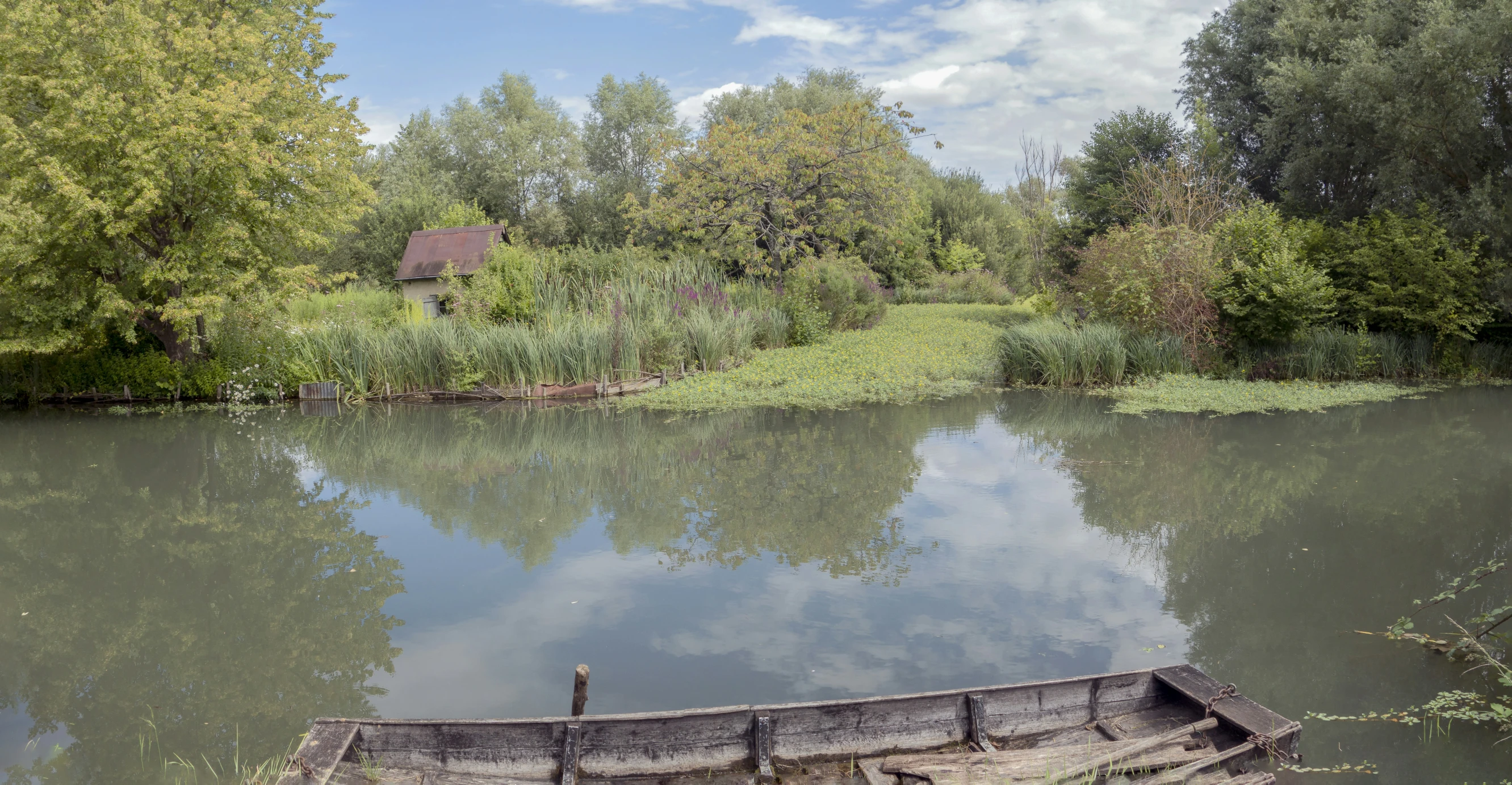 an empty canoe in the water at a lake