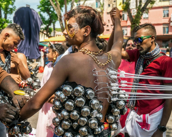 people with lots of beads standing around in the sun