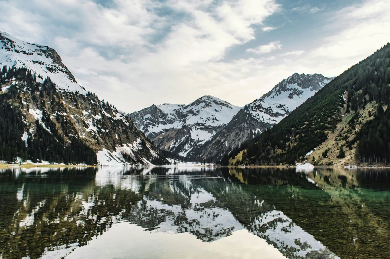 the mountains reflect in a mountain lake