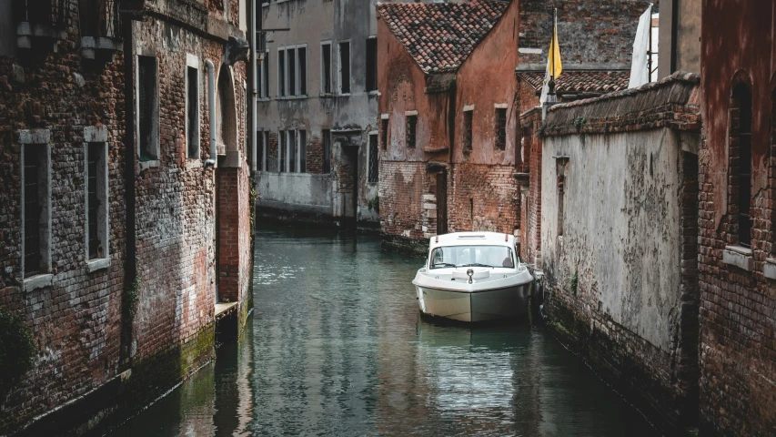 the boat is moving through the narrow canals in this ancient city