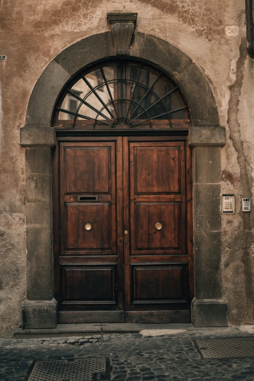 an old fashioned brown doorway that looks to be a private residence