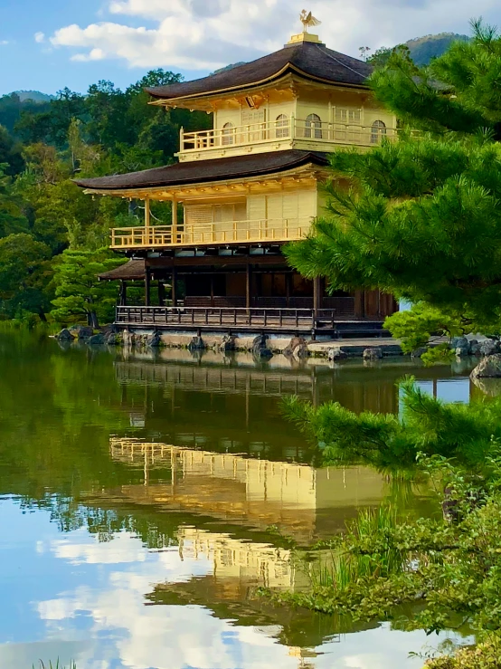 a pagoda sits on the edge of a lake