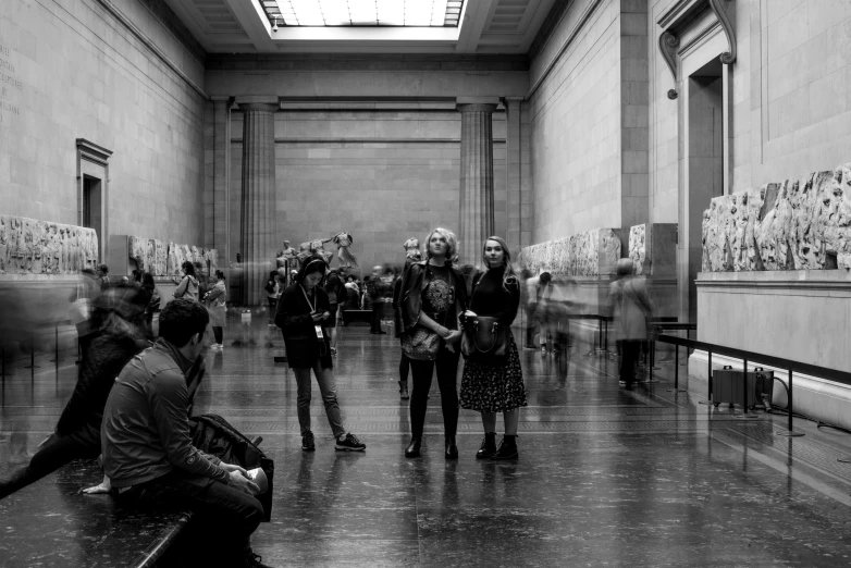 a group of people walking around a museum together