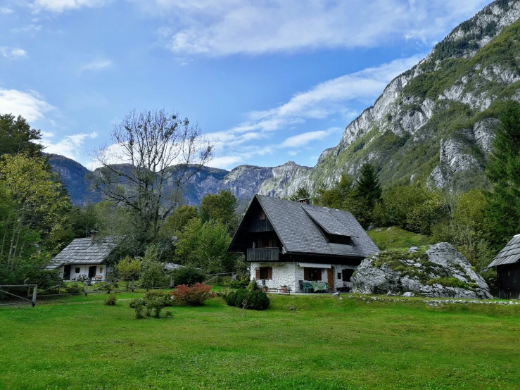 a small village sits in the woods near mountains