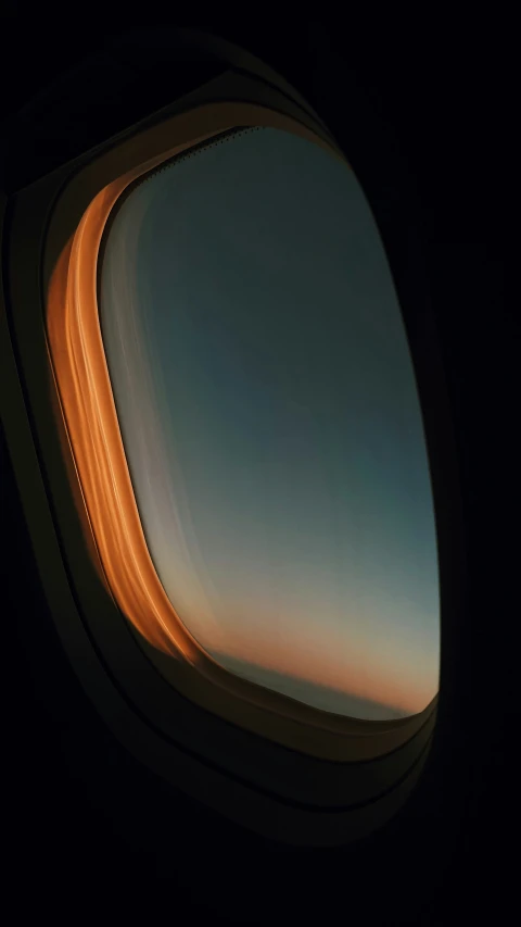 looking outside through an airplane window at the horizon