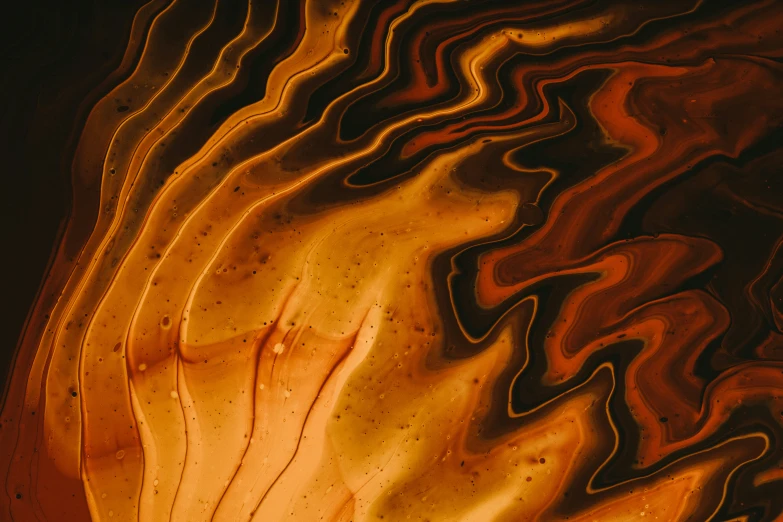 a yellow and brown swirled artwork with black background