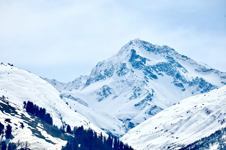 mountain in the distance with snow on the trees