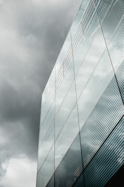 there are many clouds in the sky behind this building