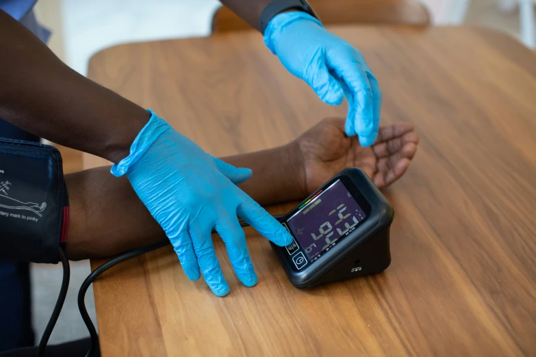 blue gloves help someone clean the leg off a smartphone