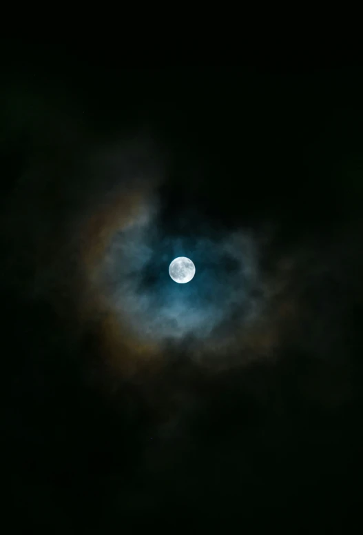 a full moon is seen in the dark sky