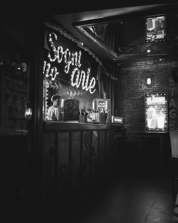 the neon sign on the brick wall of a restaurant