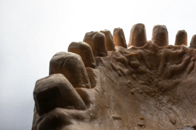 the top part of a statue with a white sky in the background