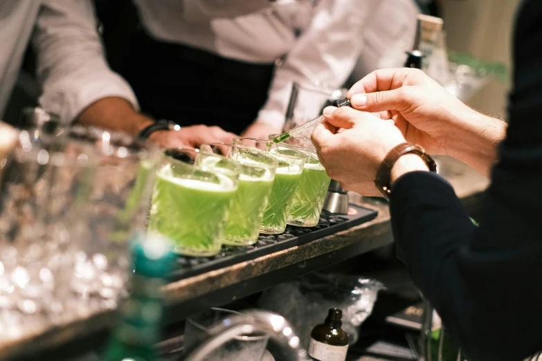 two hands are filling a tray with liquid