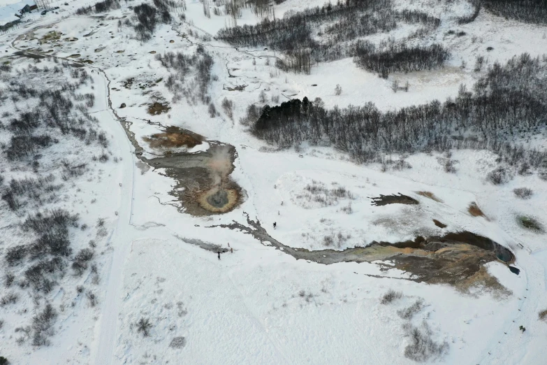 aerial view of snow covered ground and mountains