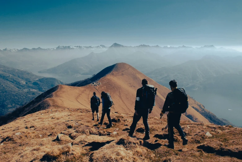 there are people walking up a mountain to see what they are doing