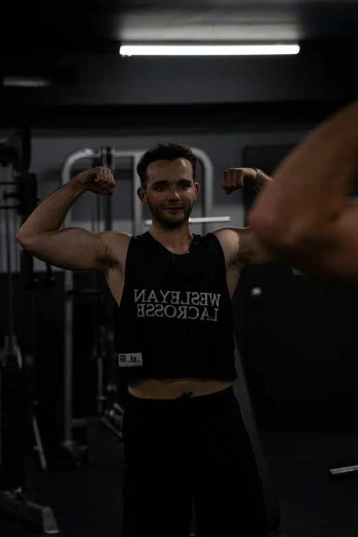 a man lifting his arm in a gym