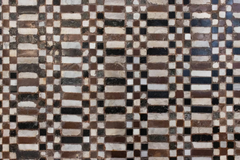 a brown and white checkered carpet with some patches of light brown